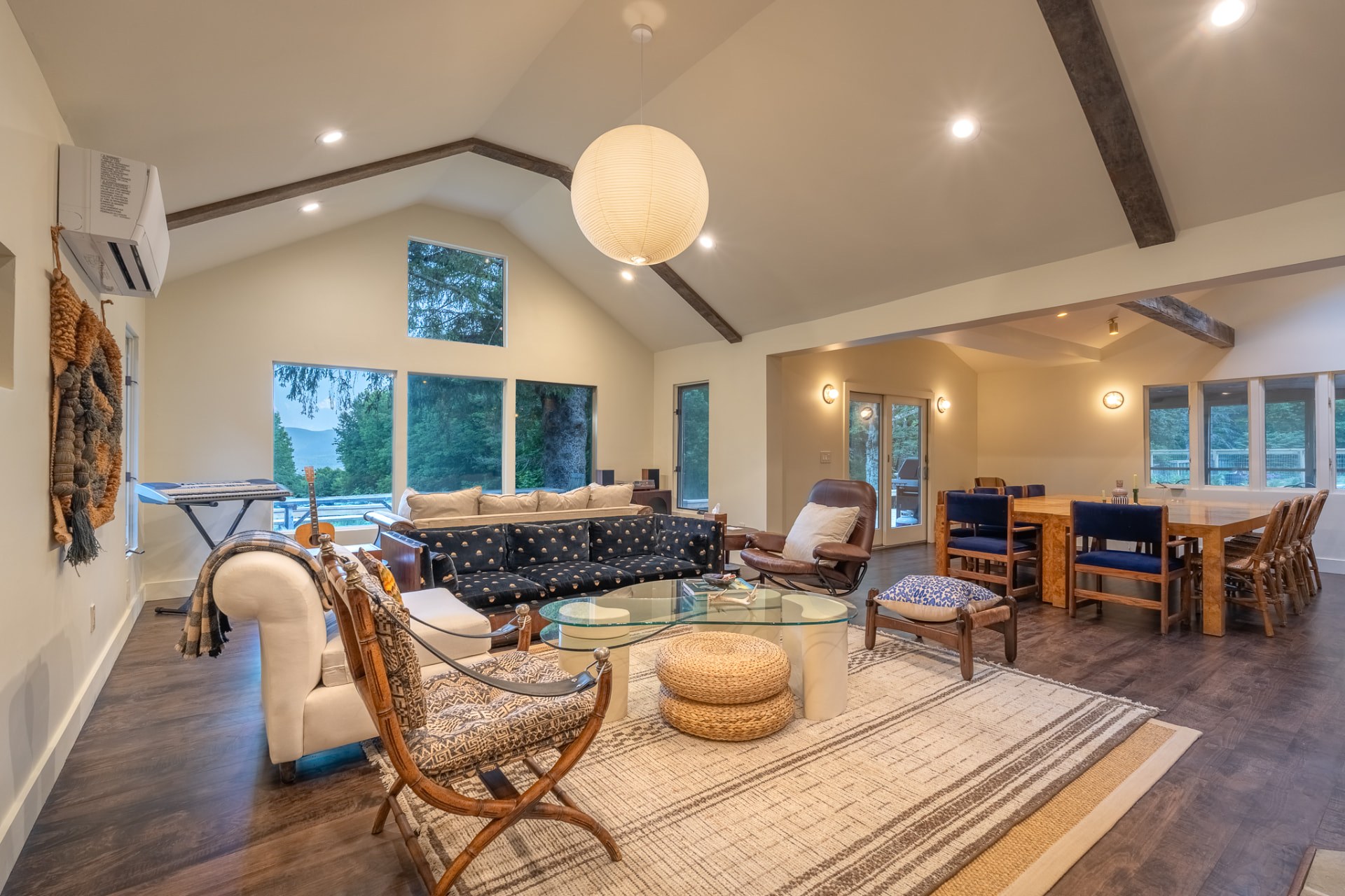 The great room with vaulted ceilings, comfortable seating, and a long dining table